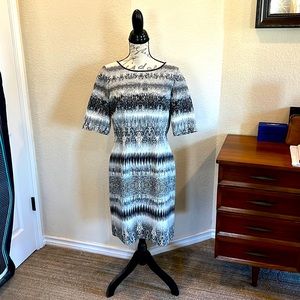Tahari size 8 black and white print dress. Stylish, leather piping.